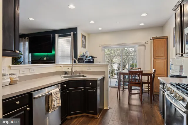 a kitchen with a sink cabinets and wooden floor