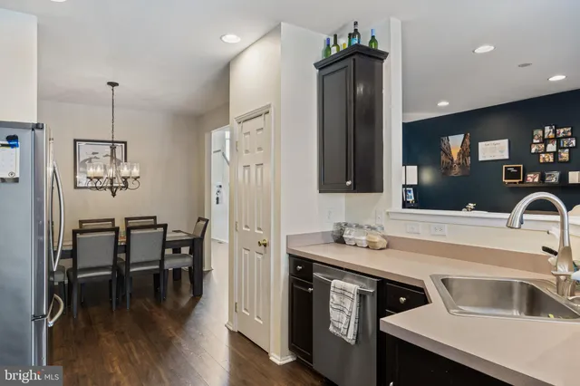 a kitchen with stainless steel appliances a stove a refrigerator and a microwave