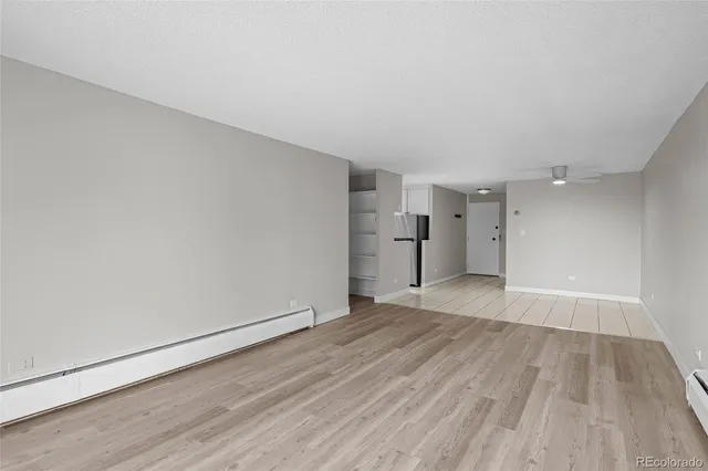 a view of an empty room and wooden floor
