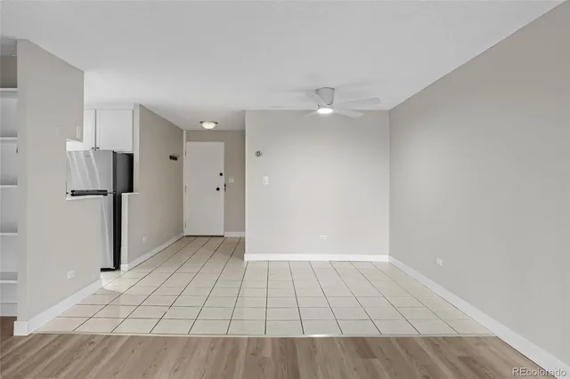 a view of an empty room with window and cabinet