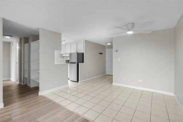 a view of a kitchen with sink refrigerator and window