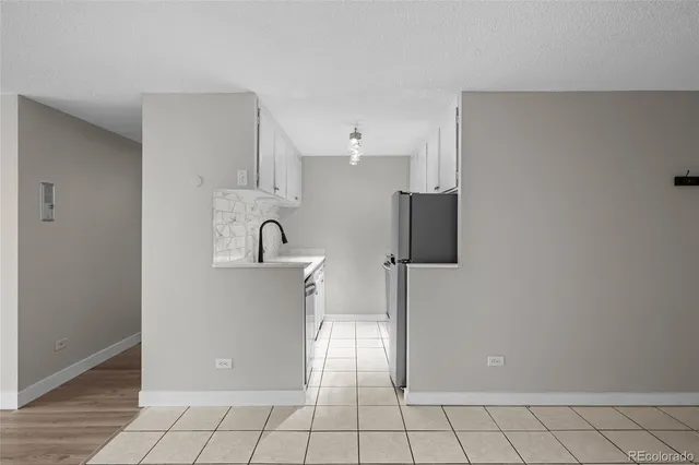 a kitchen with stainless steel appliances a refrigerator sink and microwave