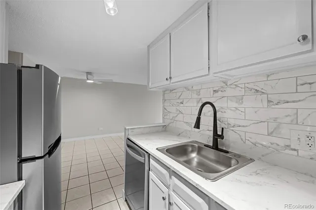 a view of a room with wooden floors and white walls