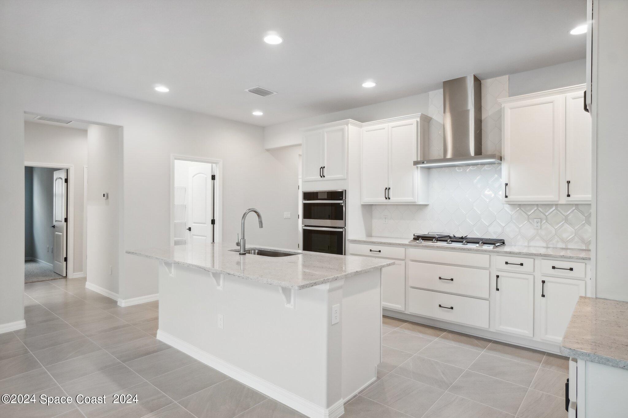 3019 Pangea Circle Melbourne, FL 32940 - Photo 16 of 56 a kitchen with stainless steel appliances granite countertop a stove and a refrigerator