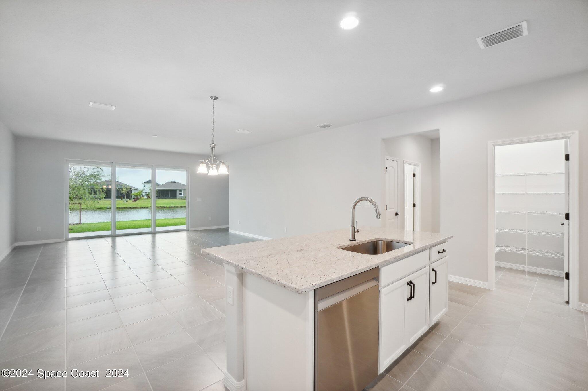 3019 Pangea Circle Melbourne, FL 32940 - Photo 17 of 56 a bathroom with a sink and a large mirror