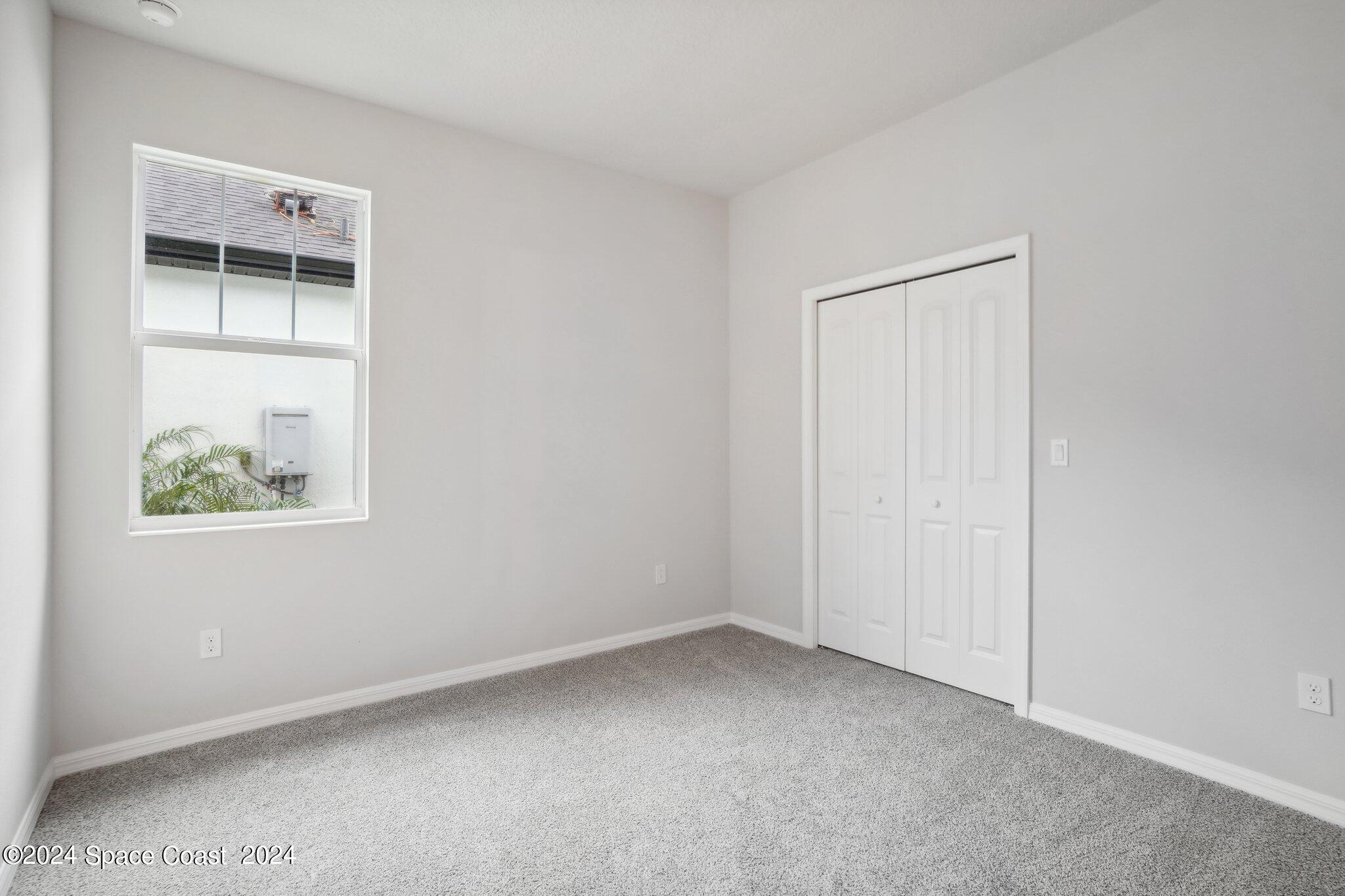 3019 Pangea Circle Melbourne, FL 32940 - Photo 32 of 56 an empty room with a window