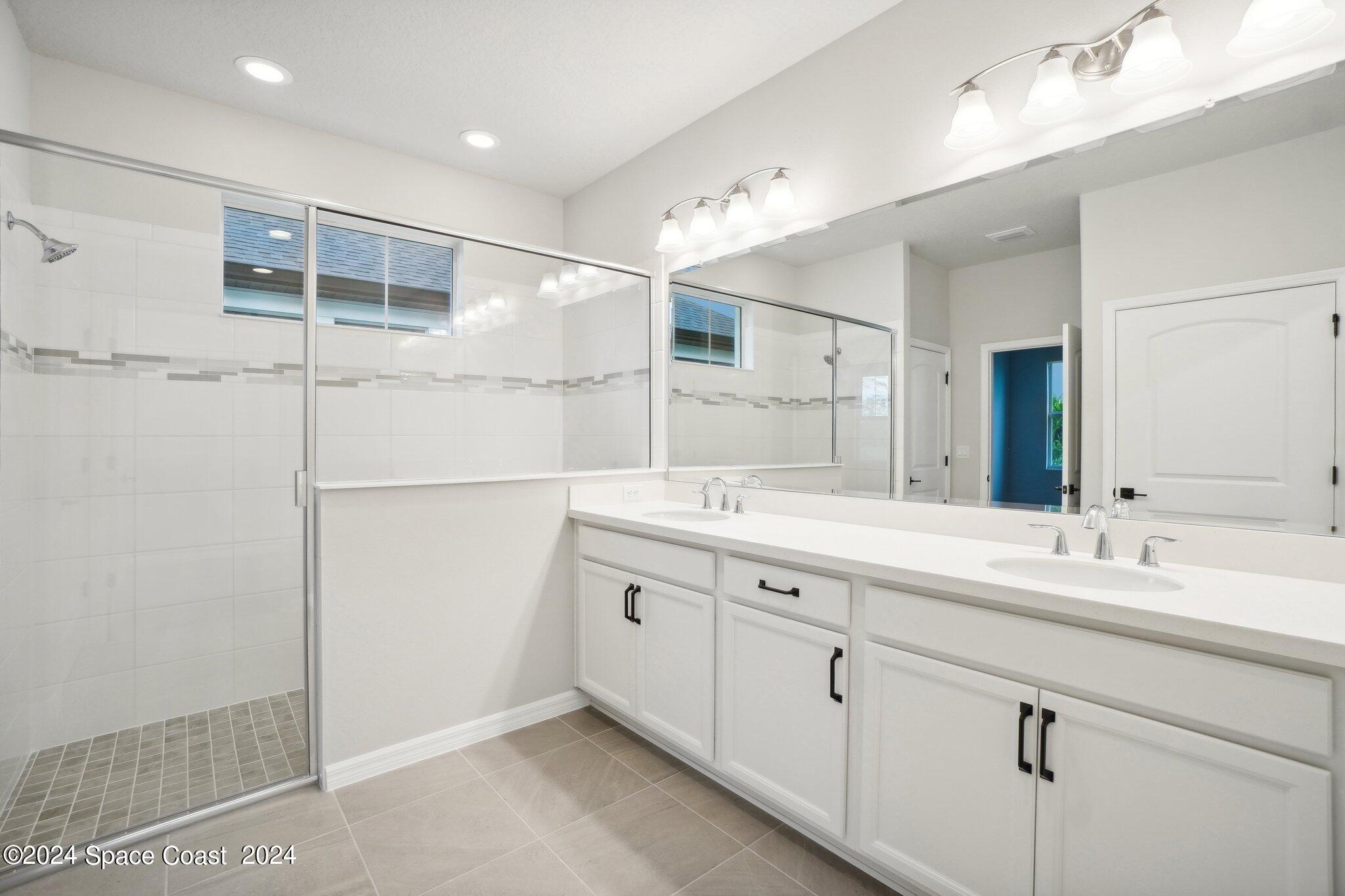 3019 Pangea Circle Melbourne, FL 32940 - Photo 43 of 56 a bathroom with a double vanity sink and mirror
