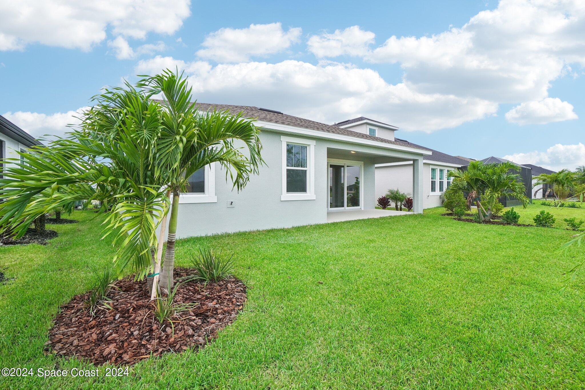 3019 Pangea Circle Melbourne, FL 32940 - Photo 45 of 56 a front view of house with yard and green space