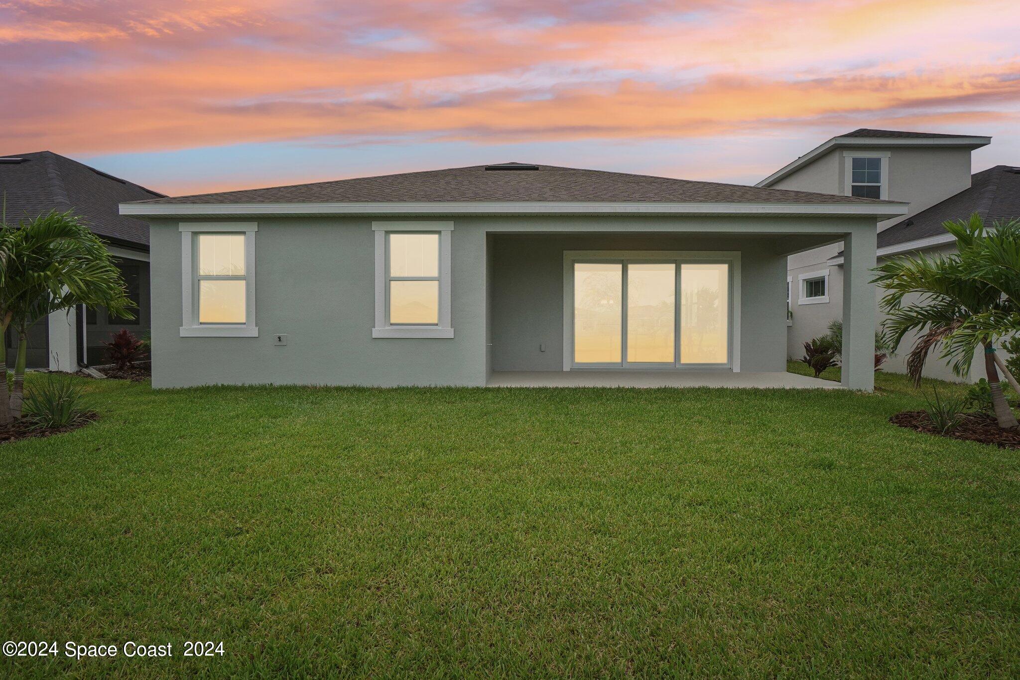 3019 Pangea Circle Melbourne, FL 32940 - Photo 46 of 56 a front view of a house with a garden