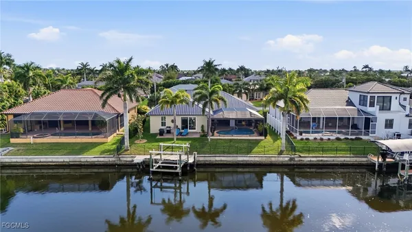 a view of house with swimming pool yard and outdoor seating