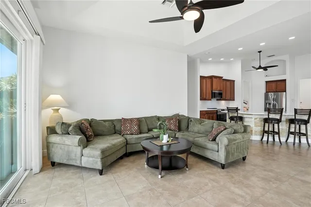 a living room with furniture and a view of kitchen
