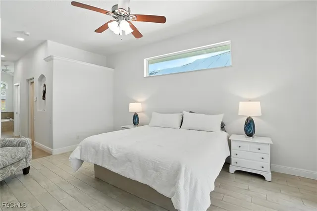 a bedroom with a large bed and a chandelier