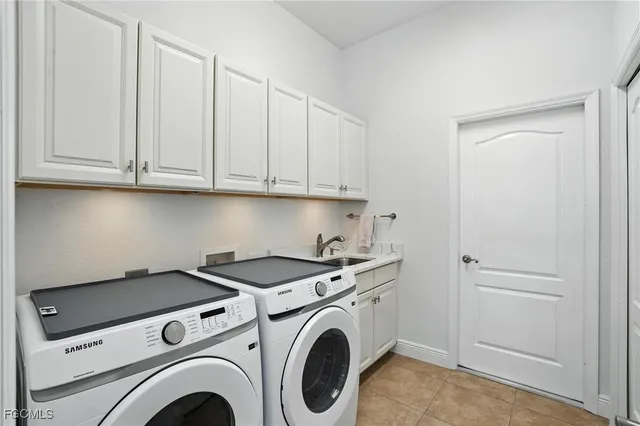 a living room with patio furniture and floor to ceiling windows
