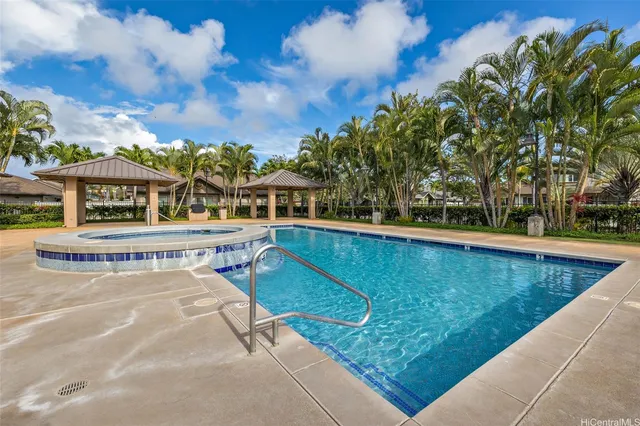 a view of swimming pool with a lounge chairs