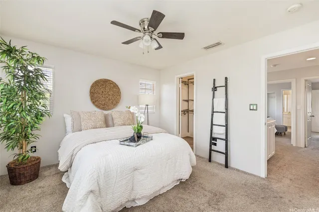 a bedroom with a large bed and a chandelier