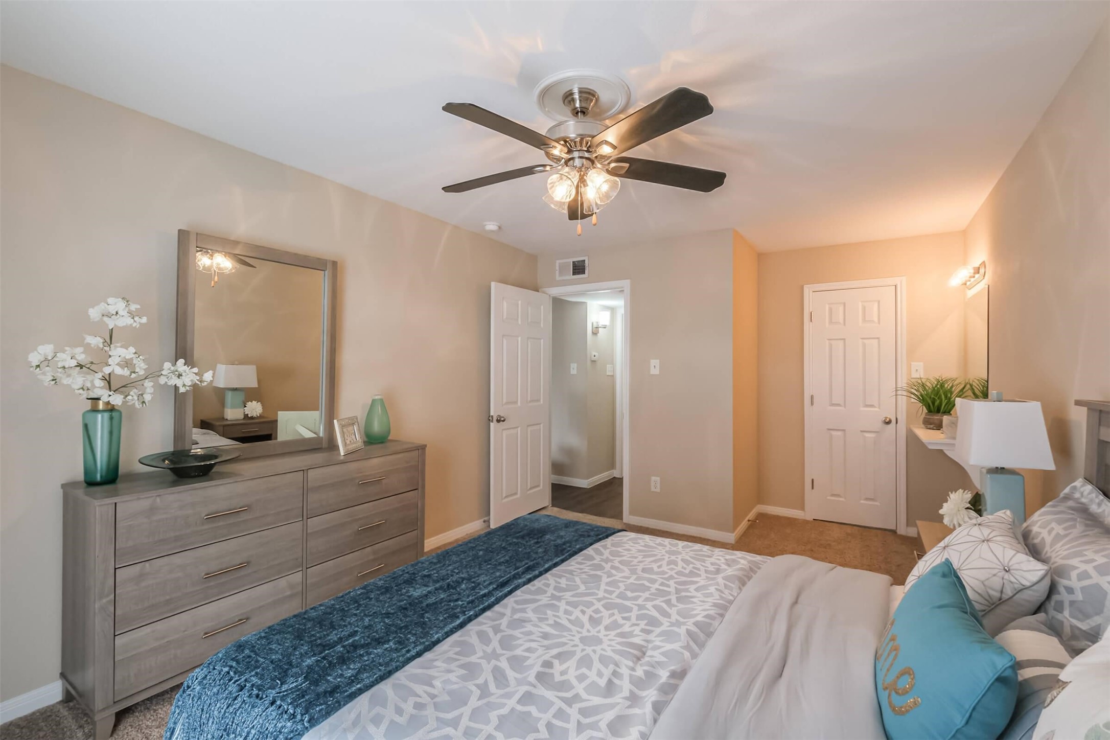 5900 North Braeswood Boulevard, Unit 258 Houston, TX 77074 - Photo 15 of 32 a bedroom with a bed and a chandelier