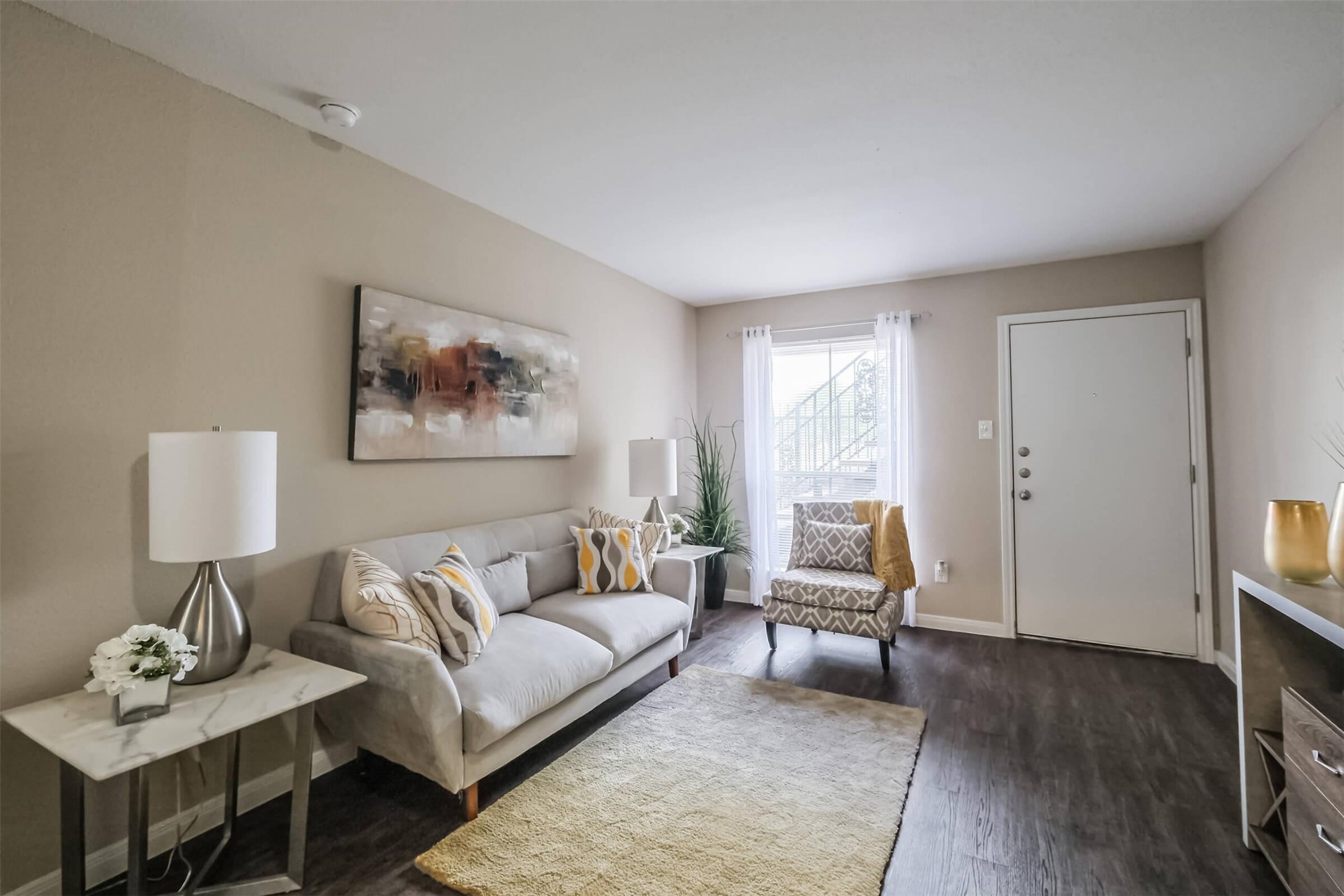 5900 North Braeswood Boulevard, Unit 258 Houston, TX 77074 - Photo 5 of 32 a living room with furniture and a wooden floor