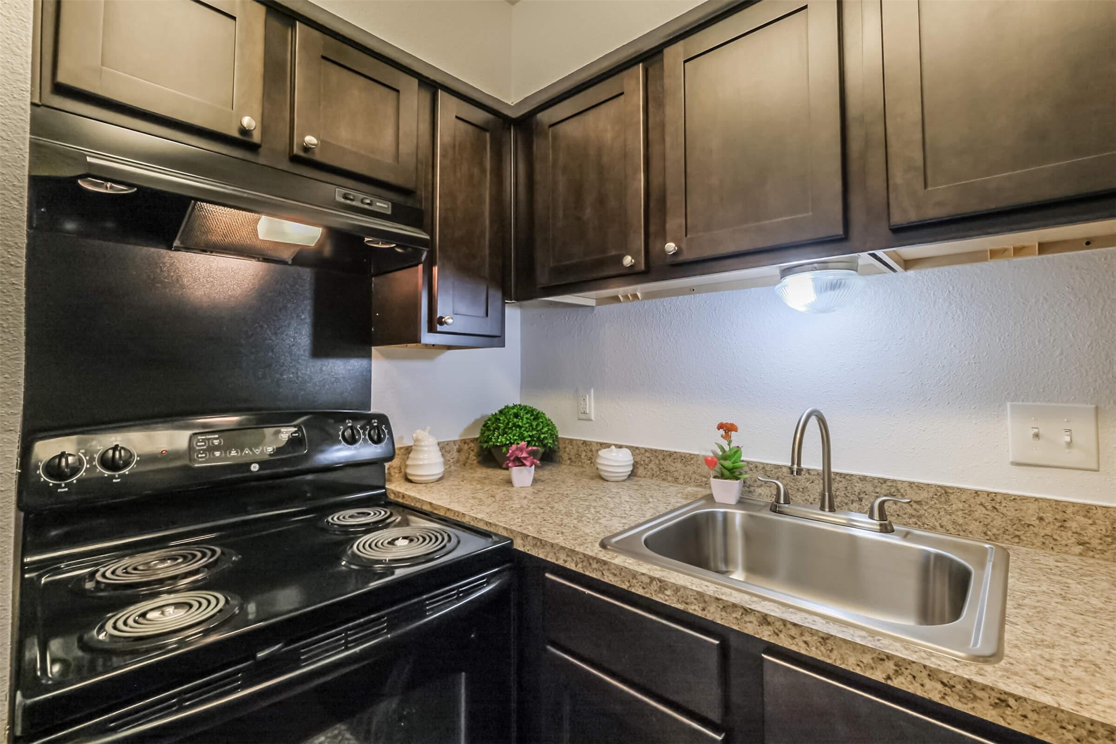 5900 North Braeswood Boulevard, Unit 258 Houston, TX 77074 - Photo 10 of 32 a kitchen with a stove and a sink
