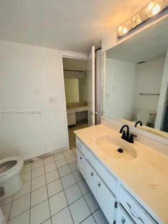 a bathroom with a sink a toilet and mirror