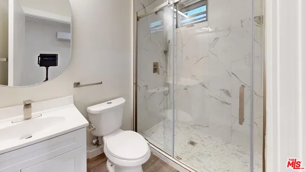 a white toilet sitting next to a bathroom sink