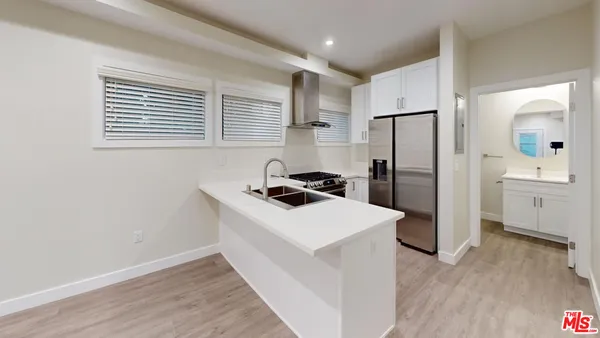 a kitchen that has a sink a refrigerator and a stove