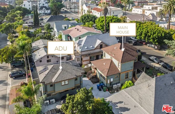 an aerial view of a residential houses with street