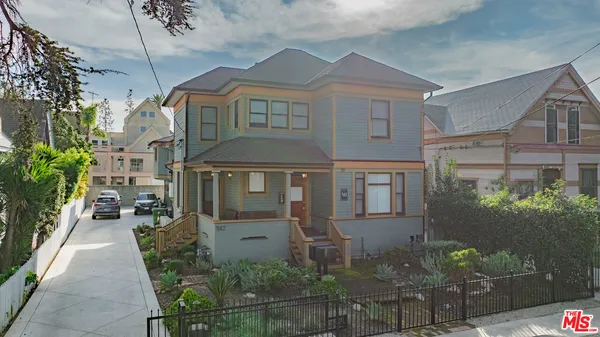 a front view of a house with plants