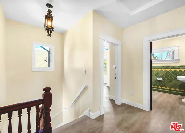 a view of a hallway view with wooden floor and staircase