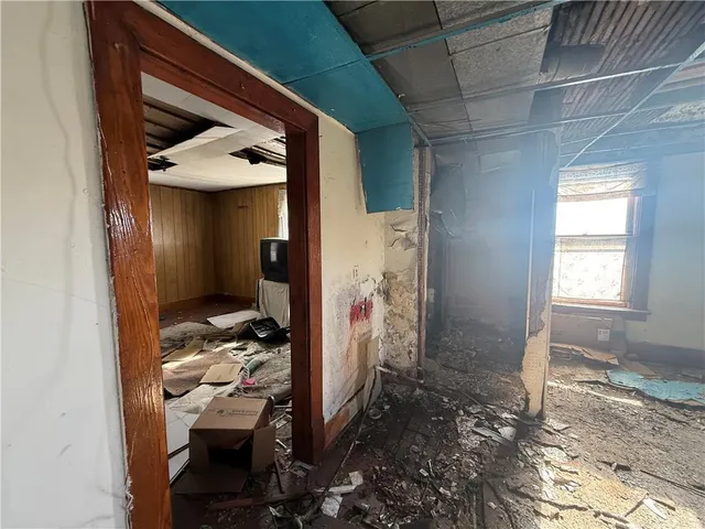 a view of a hallway with wooden walls and windows