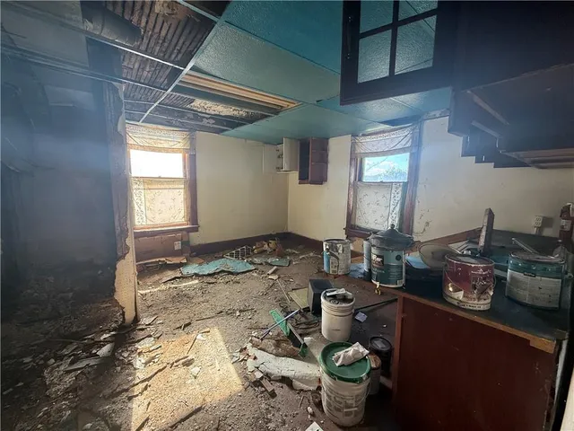 a room with water heater and wooden floor