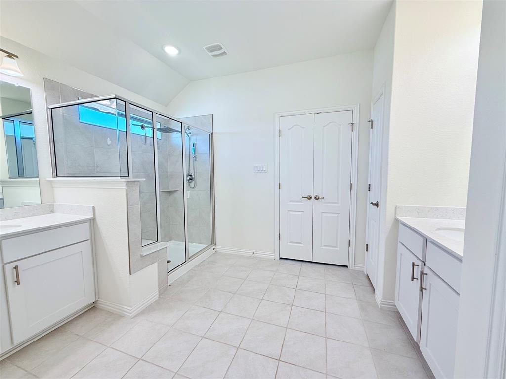1336 Morning View Road Georgetown, TX 78628 - Photo 21 of 40 A generously proportioned bathroom with dual vanities and a spacious glass-enclosed shower.