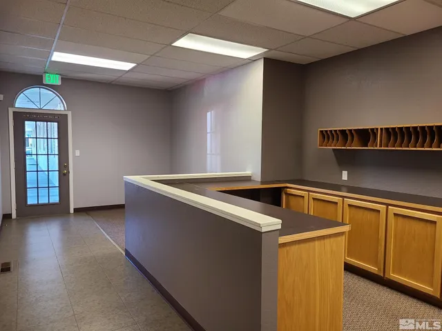 a kitchen with stainless steel appliances granite countertop a sink a stove and a wooden floors