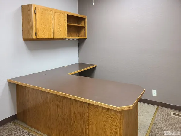 a view of kitchen cabinets and wooden floor