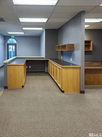 a view of a house with a large window and brick walls