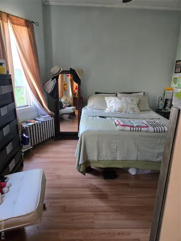 a bedroom with bed and window