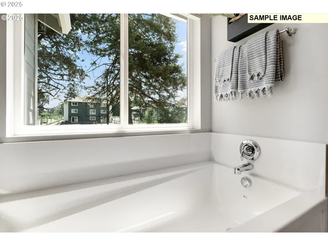 a bathroom with a bathtub and shower