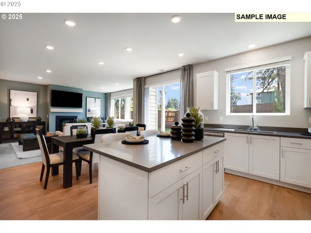 a kitchen with sink and view living room