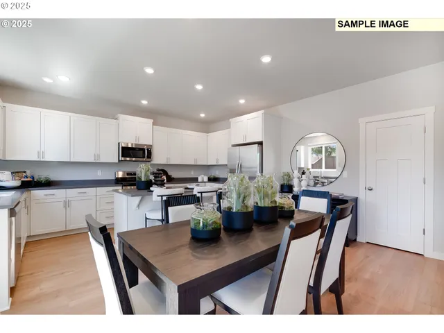 a open kitchen with stainless steel appliances granite countertop a stove refrigerator a sink dishwasher and cabinets with wooden floor