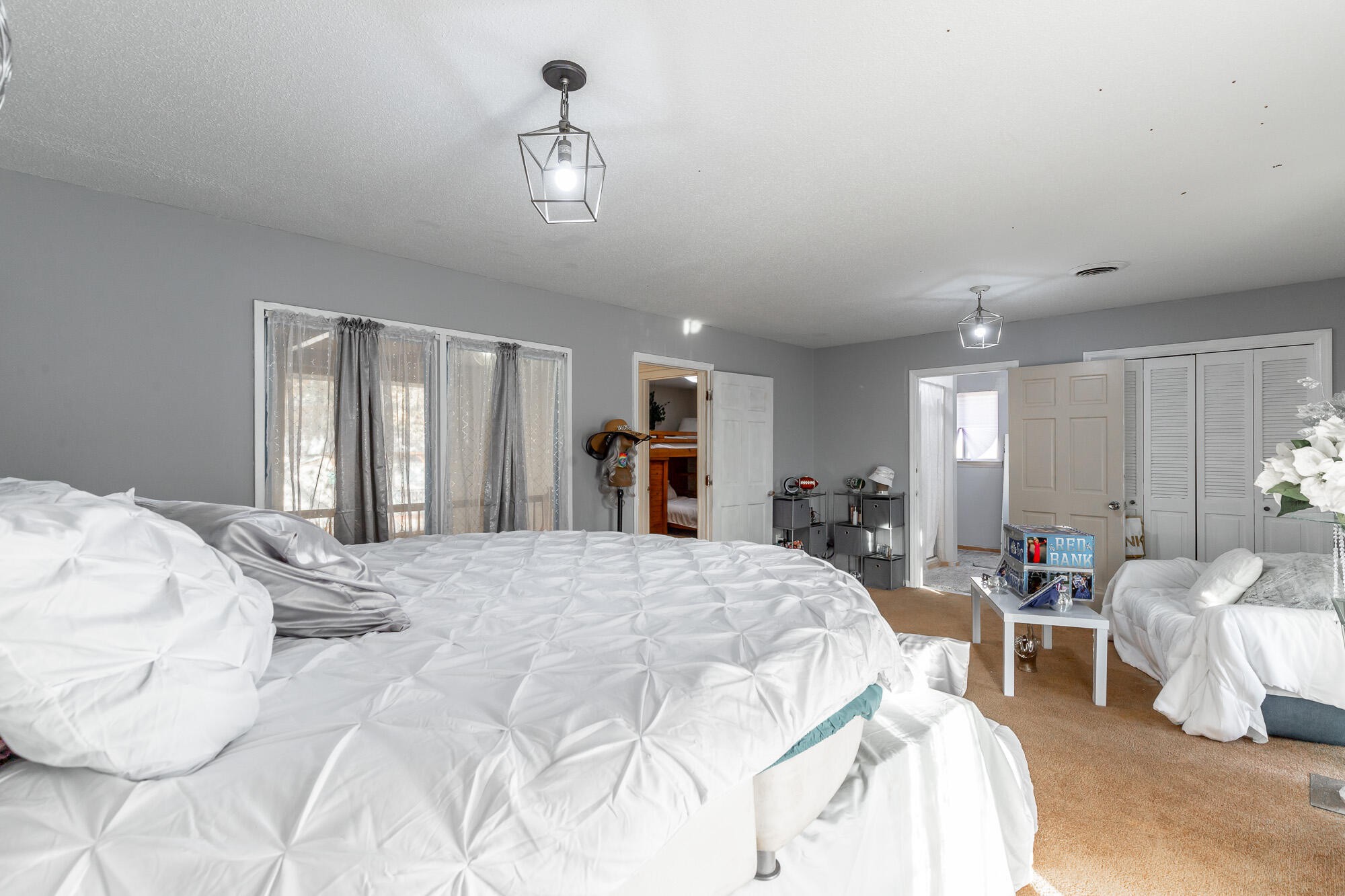 8417 Iris Drive Chattanooga, TN 37421 - Photo 47 of 90 a bedroom with a large bed and a chandelier