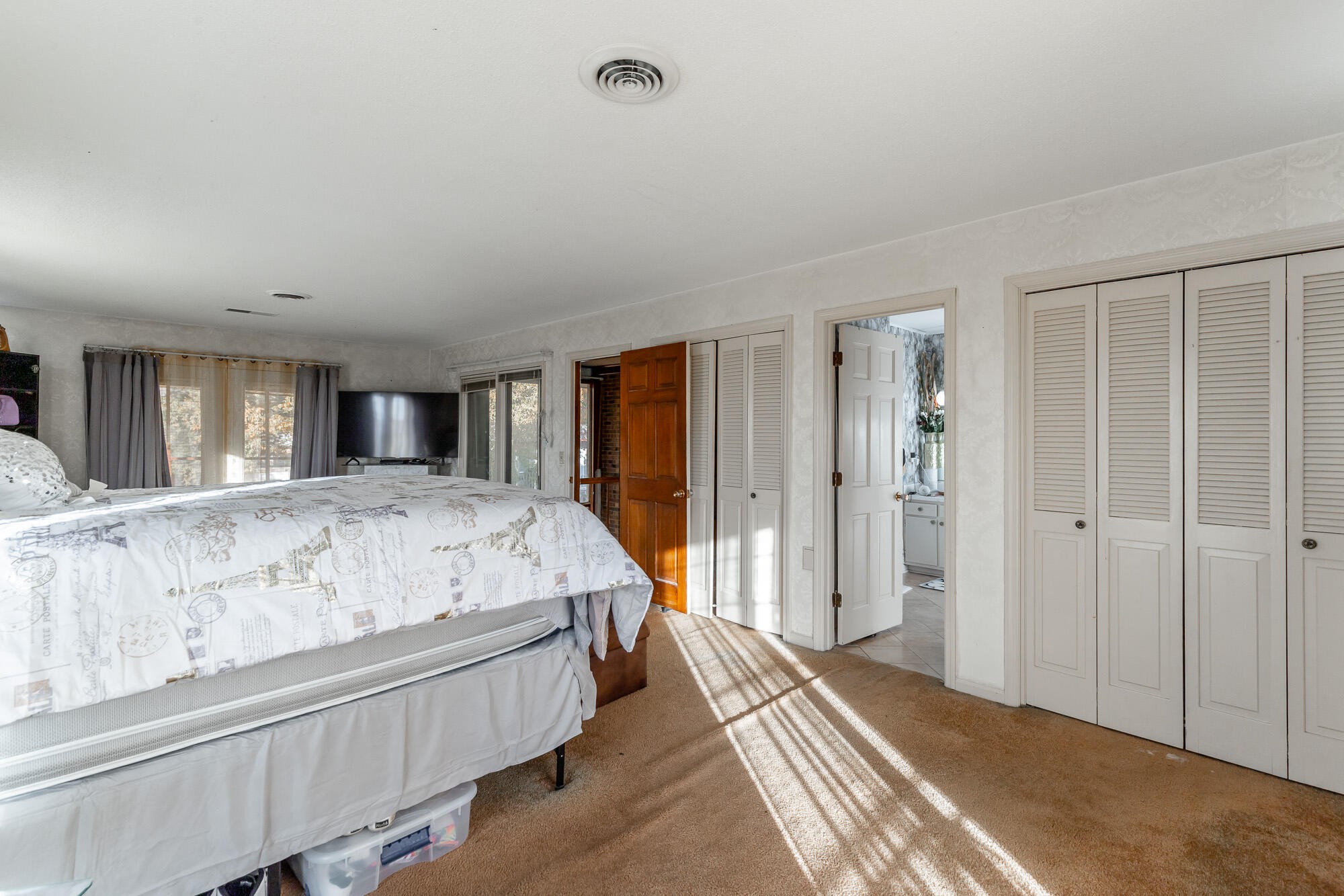 8417 Iris Drive Chattanooga, TN 37421 - Photo 51 of 90 a spacious bedroom with a large bed and a chandelier