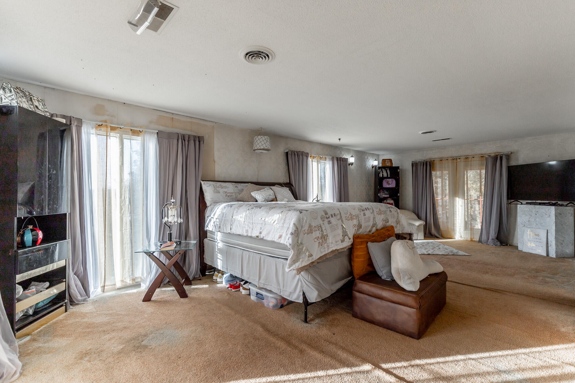 8417 Iris Drive Chattanooga, TN 37421 - Photo 52 of 90 a bedroom with a bed a couch and a flat tv screen on the dresser