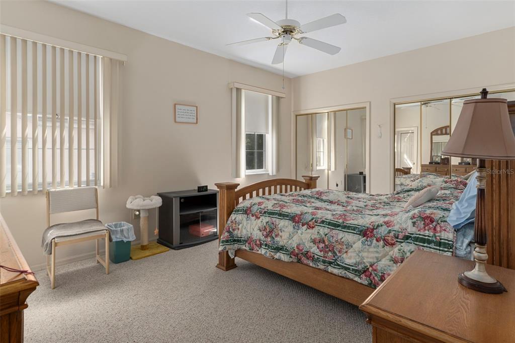 3529 South Belgrave Drive Inverness, FL 34452 - Photo 12 of 35 a bed sitting in a room next to a window with a flat screen tv