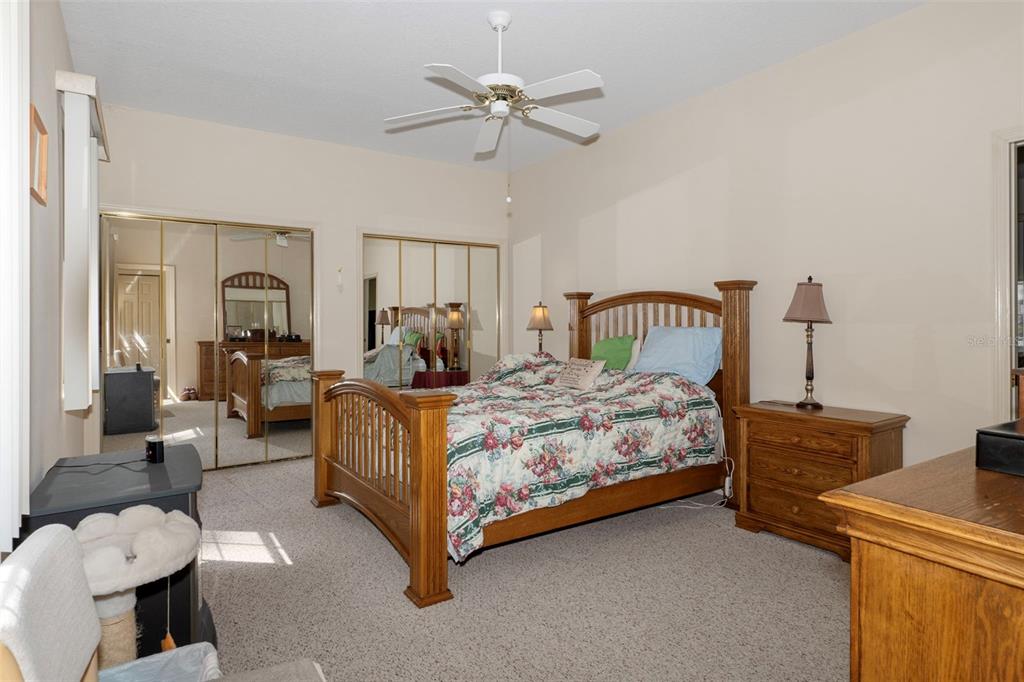 3529 South Belgrave Drive Inverness, FL 34452 - Photo 13 of 35 a bedroom with a bed couches and chandelier