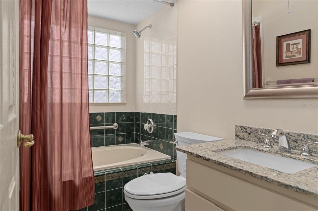 3529 South Belgrave Drive Inverness, FL 34452 - Photo 16 of 35 a bathroom with a granite countertop toilet a sink and bathtub