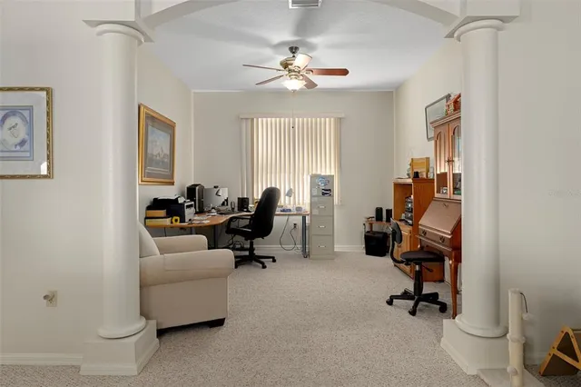 a view of a livingroom with workspace and a window