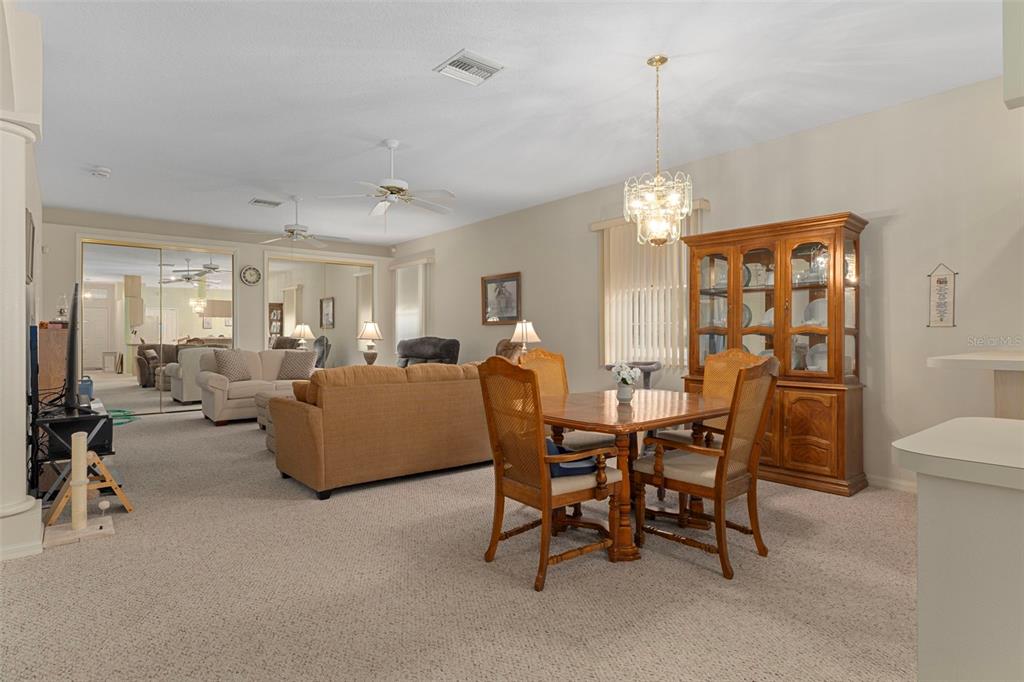 3529 South Belgrave Drive Inverness, FL 34452 - Photo 6 of 35 a living room with furniture a chandelier and a dining table