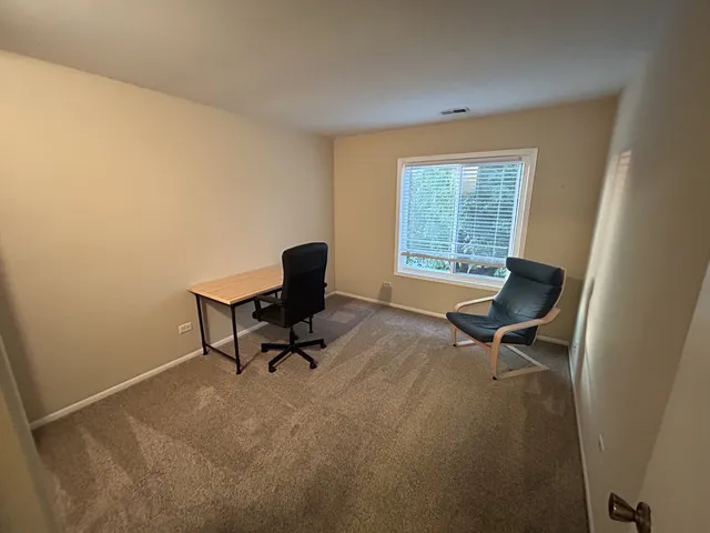 a work room with furniture and a window