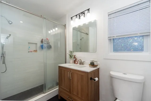 a bathroom with a sink toilet and shower