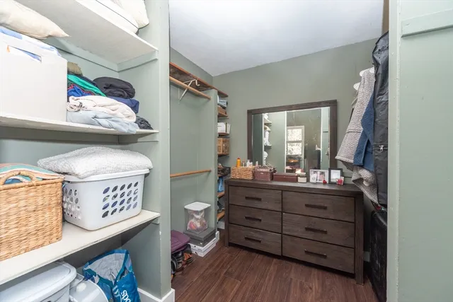 a view of room with window and wooden floor