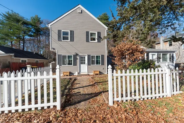 a front view of a house with a fence